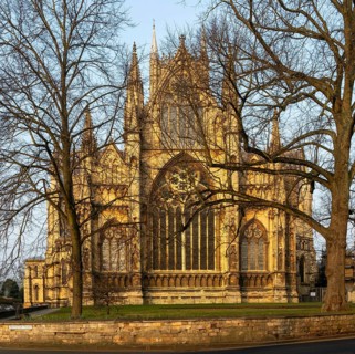 East frontage Lincoln cathedral church winter morning light viewed through tree branches, city of