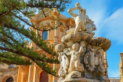 View of Hercules fountain and San Domenico church in the background, Noto Valley, Sicily, Italy,