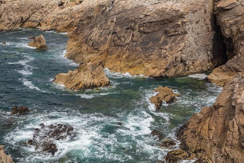 Rocky west coast of the Quiberon peninsula in Brittany, France. Crashing waves and rocks
