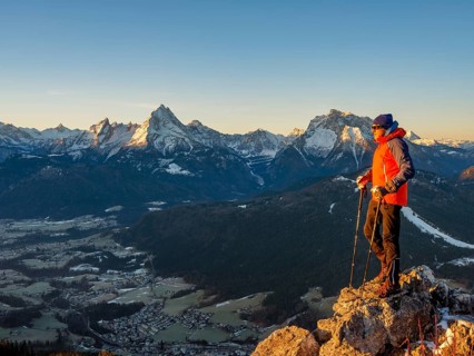 Mountaineers on the summit of Rauher Kopf at sunrise, behind them the Berchtesgaden Alps,