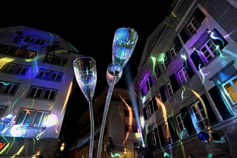 Light installation, on building facades and sculptures in the form of glasses in the old town,