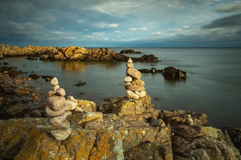 Rocky coast with cairns in the morning light, Allinge-Sandvig, Bornholm, Denmark, Europe