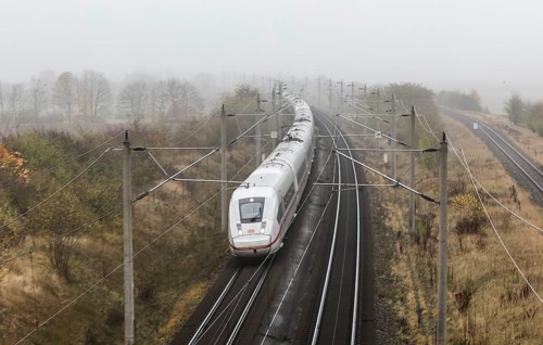 A Deutsche Bahn ICE train runs in foggy autumn weather on a railway line near Neugarten, 06.11