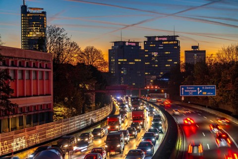 Evening traffic, partly with traffic jams, slow-moving traffic on the A40 motorway, skyline of