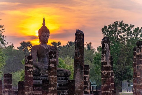 Sunset at a Buddha statue of the temple Wat Mahathat, UNESCO World Heritage Sukhothai Historical