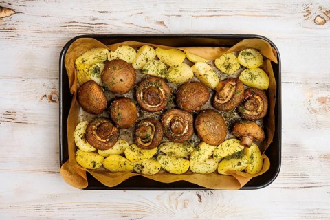 Champignon mushrooms and tender potatoes are seasoned with herbs and roasted to perfection on a
