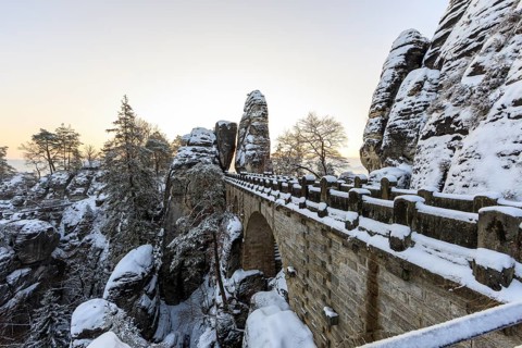 Snow on the Bastei bridge, rock gate and rock castle Neurathen in the morning, Saxon Switzerland,
