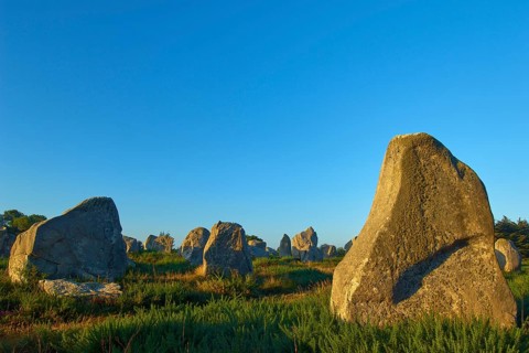 Neolithic menhirs, standing stones in Carnac with sunrise, Carnac, Quiberon, Morbihan, Brittany,