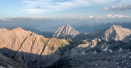 Impressive rocky mountain landscape in the evening light, view from the summit of the Zugspitze to