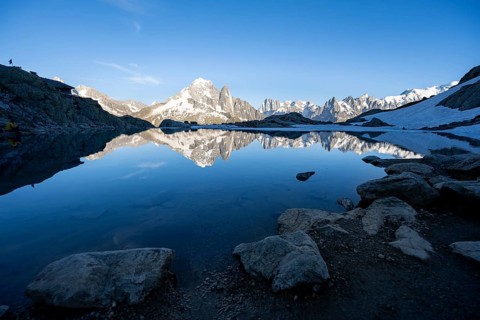 Mountain landscape in the evening light, water reflection in Lac Blanc with mountain hut Refuge du