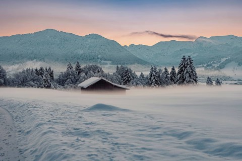 Deep snowy winter morning mood near Halblech in the foothills of the Alps in the Allgäu with the