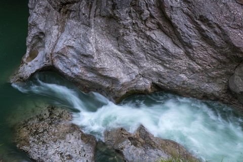 The Lammer creek is flowing fast through the Lammerklamm on a sunny hiking day
