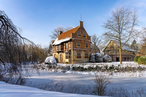 The snow-covered moated castle Haus Bisping in winter, Drensteinfurt, Münsterland, North