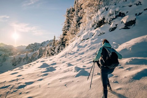 Hiking in the snow in the snow-covered winder landscape in the Alps at Neunerköpfle in the