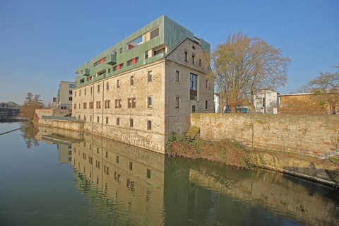 Historic Karlshospital built in 1721 and former penitentiary on the river Fulda, baroque, modern
