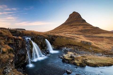 Kirkjufell mountain with Kirkjufellfoss waterfall, cloudy mood, Grundarfjördur, Snäfellsnes