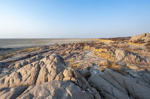 View over round rocks from Kubu Island (Lekubu) to the salt pan, at sunrise, Sowa Pan, Makgadikgadi