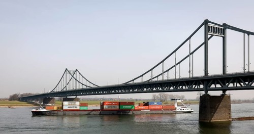 Krefeld, North Rhine-Westphalia, Germany - Cargo ship crosses the Rhine under the Krefeld-Uerdingen