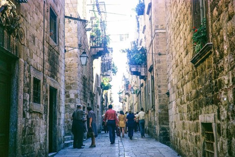 People walking along narrow street in old town of Dubrovnik, Croatia, former Yugoslavia, Europe