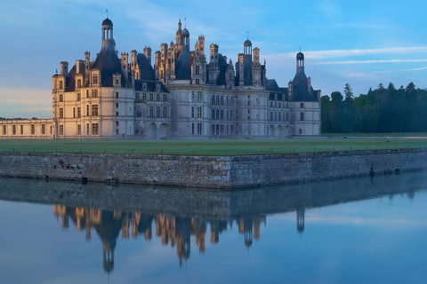 Chambord Castle with moat at sunrise, Chambord, Department Loir-et-Cher, Centre region, France,