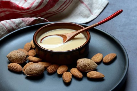 White almond cream in small bowls, almond butter