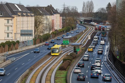 Essen, North Rhine-Westphalia, Germany - Cars and a public bus drive through Essen city centre on