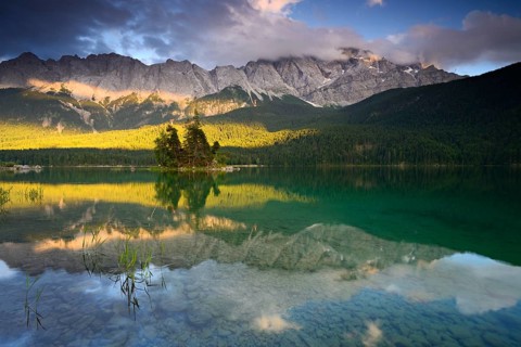 Evening mood at the Eibsee lake, behind the Wetterstein mountains with the Zugspitze, clouds move