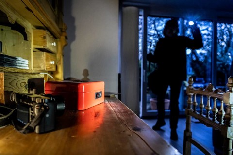 Symbolic image of a burglary, perpetrator has broken into a flat from the garden side and is