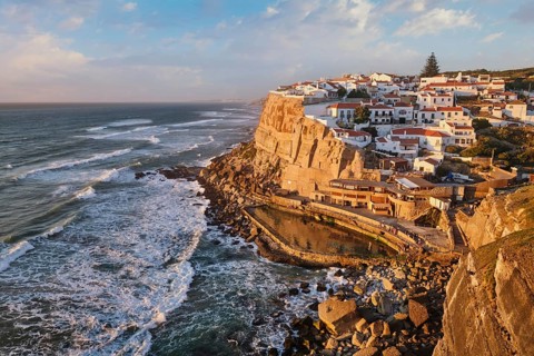 Scenic view of the seaside Azenhas do Mar fishing village on cliff on Atlantic ocean coast,