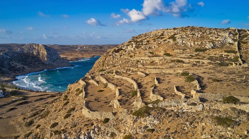 Drone shot, archaeological site, coastal landscape with ruins, sea view and blue sky, ruins of an