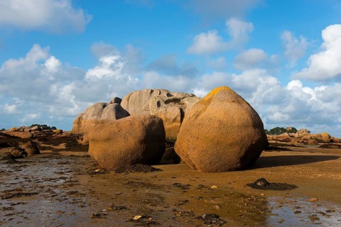 Rock formations under a bright blue sky on the coast, Baie de Sainte-Anne, Trégastel, Tregastel,