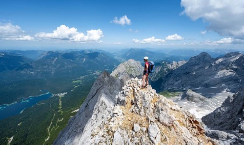 Mountaineer with helmet on a mountain ridge, ascent to the Zugspitze, Zugspitze via ferrata,