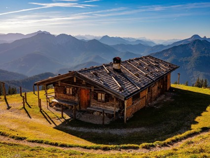 Wildfeldalm in front of alpine panorama, silhouette of mountain ranges, Mangfall mountains,