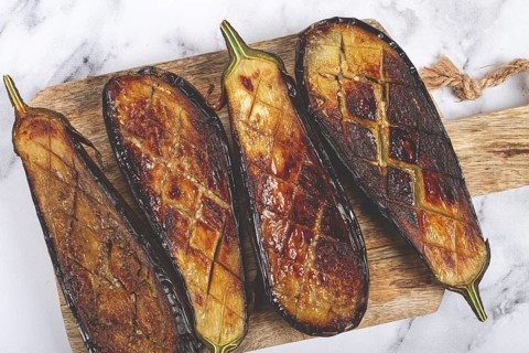 Sliced fried eggplant, on a chopping board, top view, homemade, no people