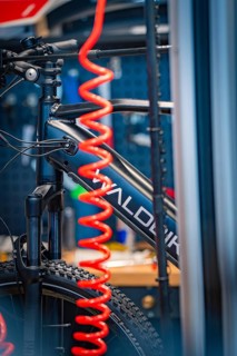 Close-up of a bicycle with a red inner tube in a workshop environment, focus on technology,