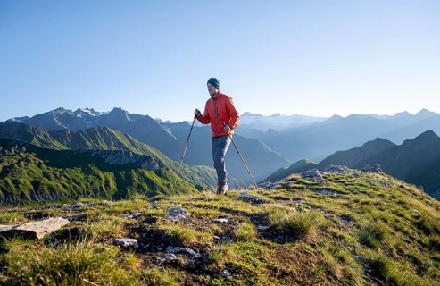 Hiker enjoying the mountain panorama in the morning, Venediger group, behind Dreiherrenkopf,