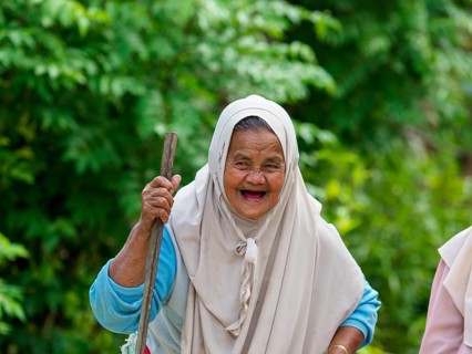Old muslim woman, laughing with stick, Sulawesi, Indonesia, Asia