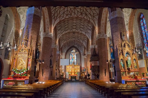 Impressive nave with vaulted ceiling and rows of wooden benches, St Jakobi Church, Olsztyn,