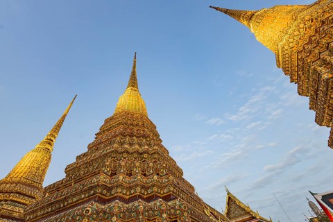 Wat Pho temple at sunset. Bangkok's oldest Buddhist monastery near the Grand Palace. Four chedis