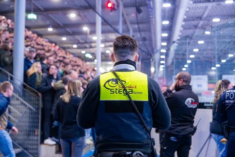 Security personnel monitor a large crowd in a crowded arena, Heilbronn Falken Vs Bietigheimer