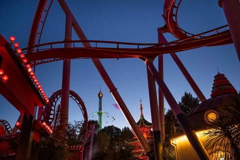 Roller coaster, chain carousel and pagoda at night, Tivoli Amusement and Recreation Park,