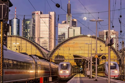 Frankfurt main station with ICE train in the evening, full moon and sunset. View of platform and