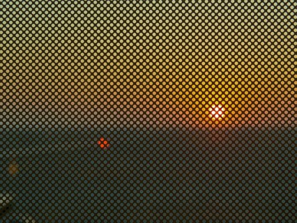 Berlin BER Airport, view through perforated window panes, taxiway at sunrise in November, Berlin,