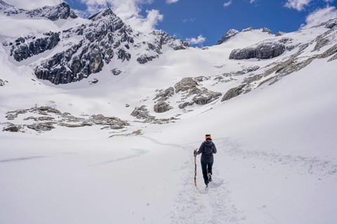 Woman hikes across a snowfield, Glaciar Vinciguerra, Ushuaia, Tierra del Fuego Province, Argentina,
