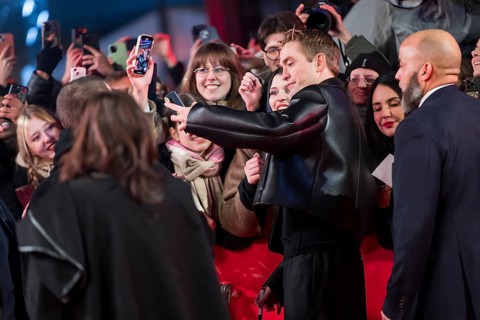 Robert Pattinson takes selfies with fans on the red carpet at the Special Gala of the film Mickey