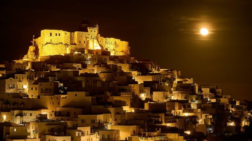 Full moon night over an illuminated settlement with castle, dramatic lighting, Querini Castle,