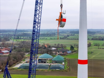 Assembly of an Enercon E-138 wind turbine, the stator, part of the generator is pulled to the