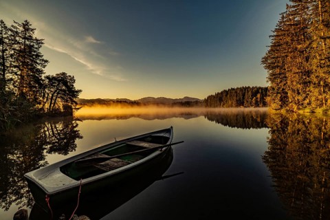 Boats in the autumnal Schmutter Weiher in the Allgäu near the municipalities of Halblech,