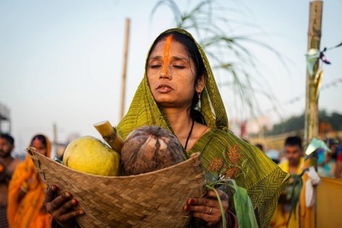 Hindu devotees perform rituals as they offer prayers to the Sun god in the bank of Brahmaputra