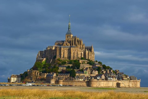 Picturesque view of Mont Saint-Michel on an island with medieval architecture, summer, Le